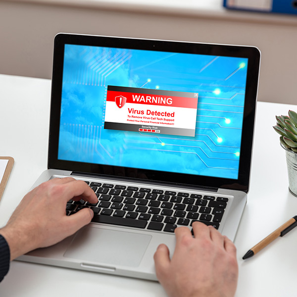 Virus detected warning text on a laptop screen