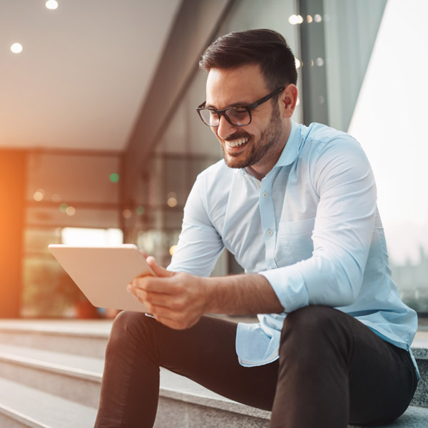 man looking at ipad outside